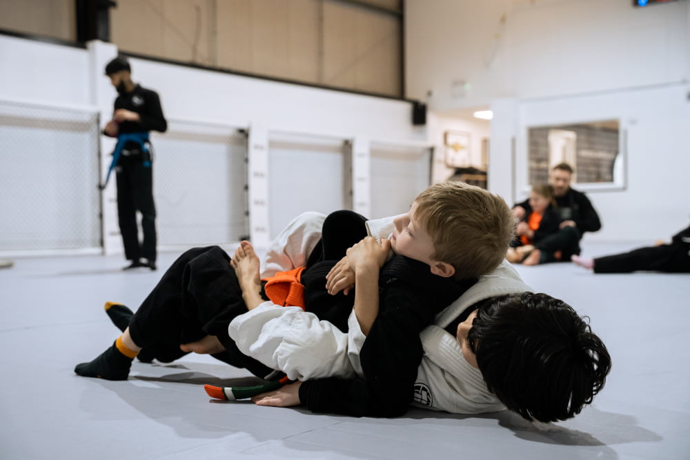 Two Ninja School students practice jiu jitsu together.